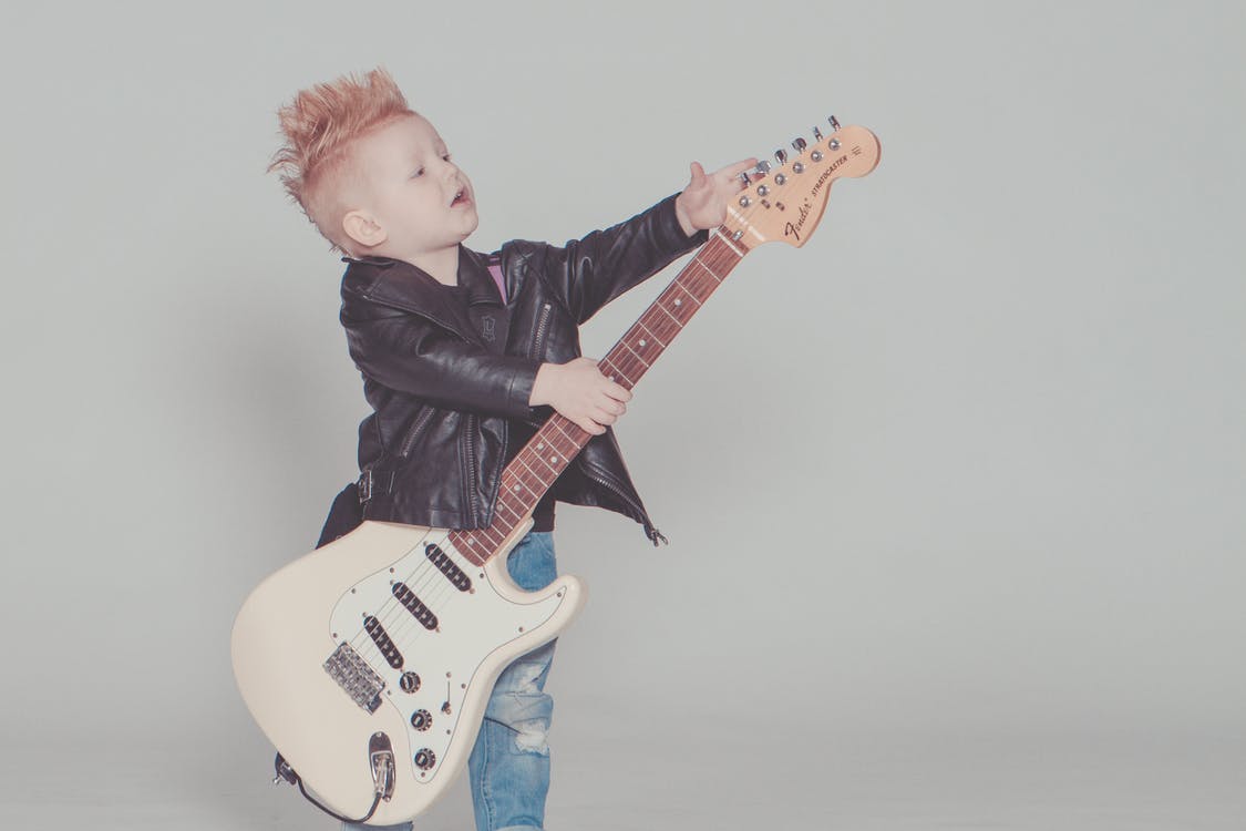 kid playing guitar rockstar
